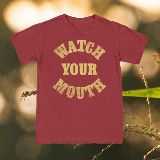 Maroon t-shirt with 'Watch Your Mouth' text on a natural background