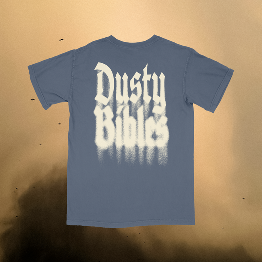 Blue t-shirt with 'Dusty Bibles' text on a beige background